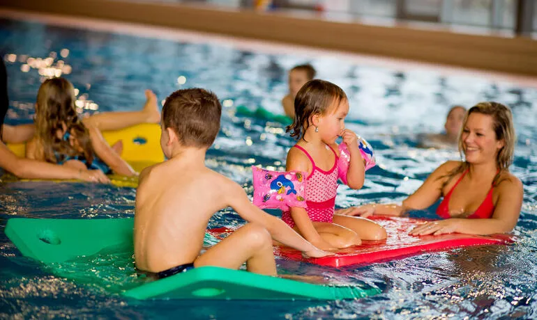 Children swimming lesson in pool