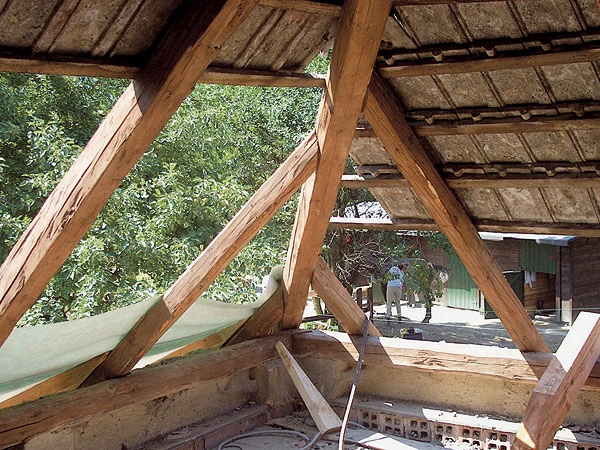 Detail dřevěného trámového spojení v střešní konstrukci.