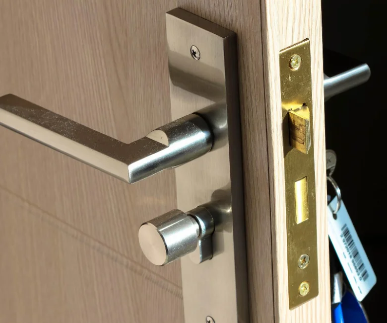 Detailní pohled na zámek a kliku uvnitř dveří.