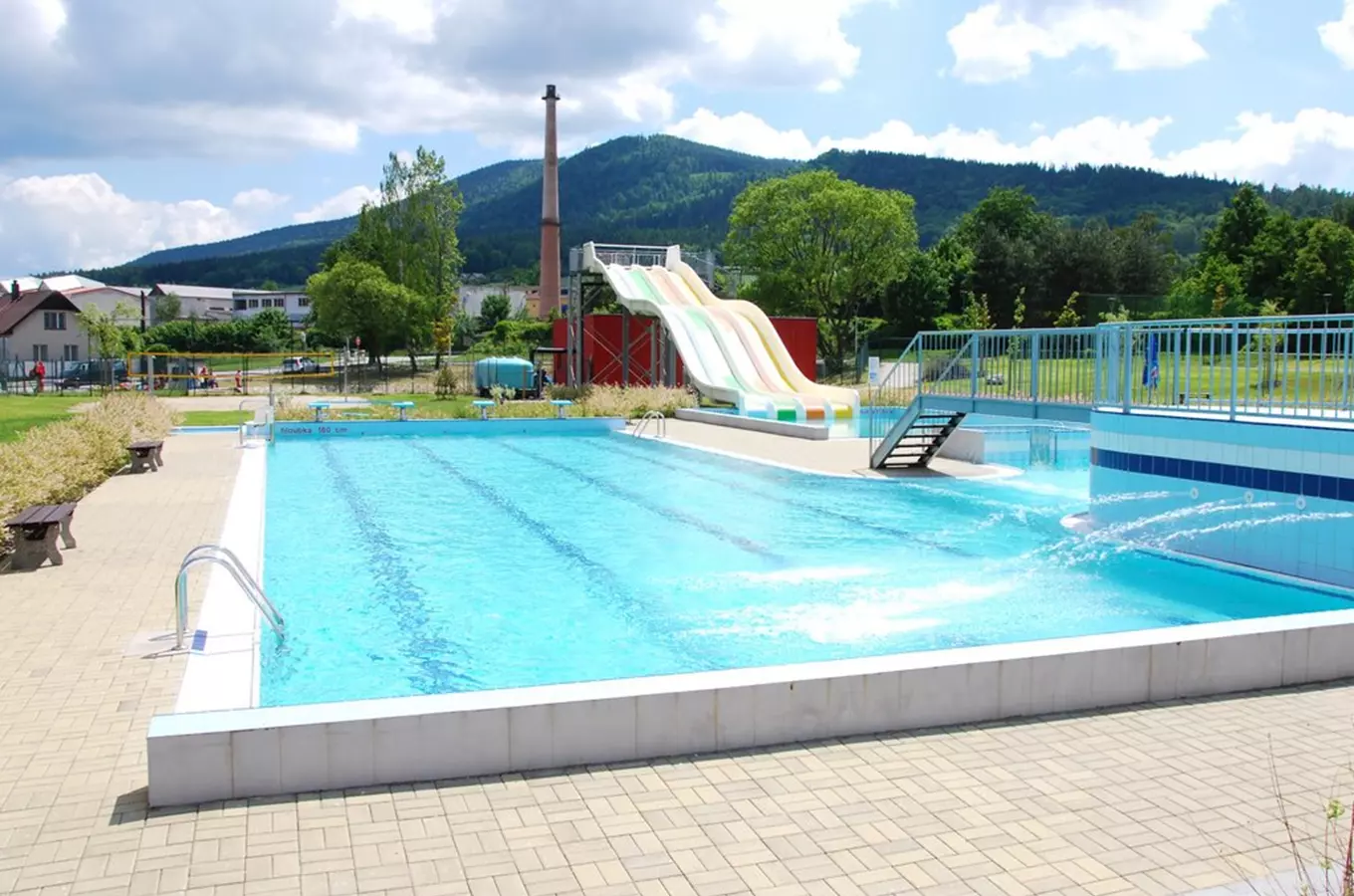 Outdoor swimming pool with slide