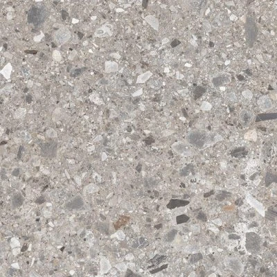 Detail velkoformátové venkovní dlažby s kamennou texturou.