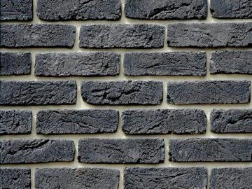 Tmavá cihlová zeď jako žáruvzdorný materiál pro krb.