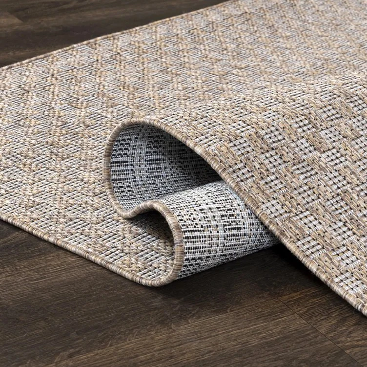 Textured area rug on wood floor