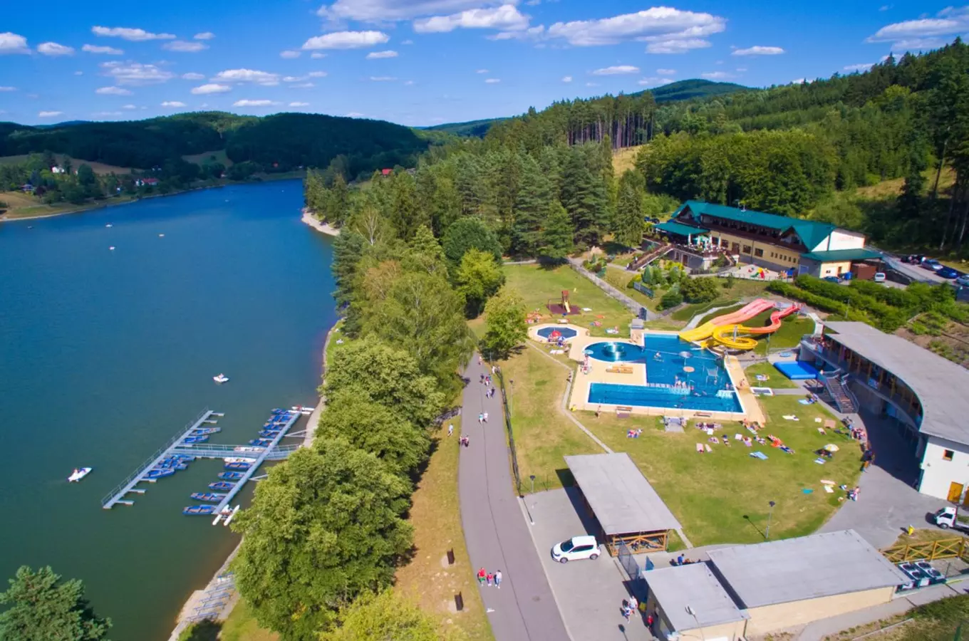 Aquapark by lake with slides and pool