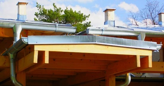 Montáž oplechování střechy s instalací závětrných lišt na dřevěném rámu.