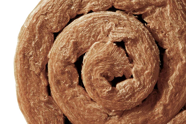 Detail minerální vlny ve spirálovém rozevřeném válcovém plášti.
