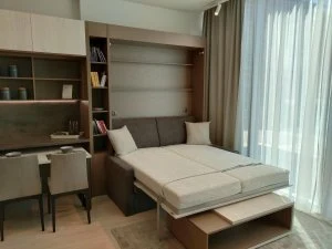 Modernní dřevěný interiér s postelí v budované skříni