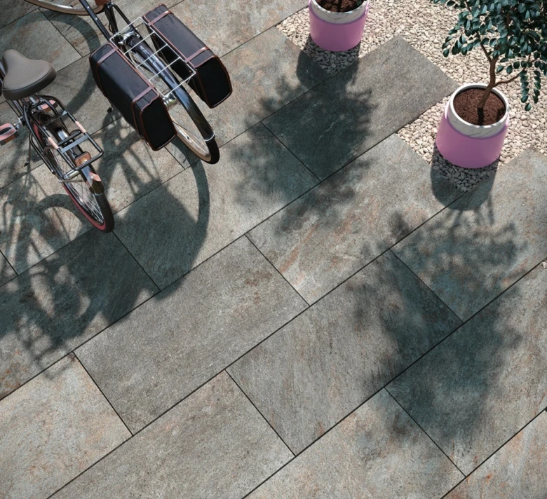 Dlažba na terče s bicykly a květinami v přírodním světle.